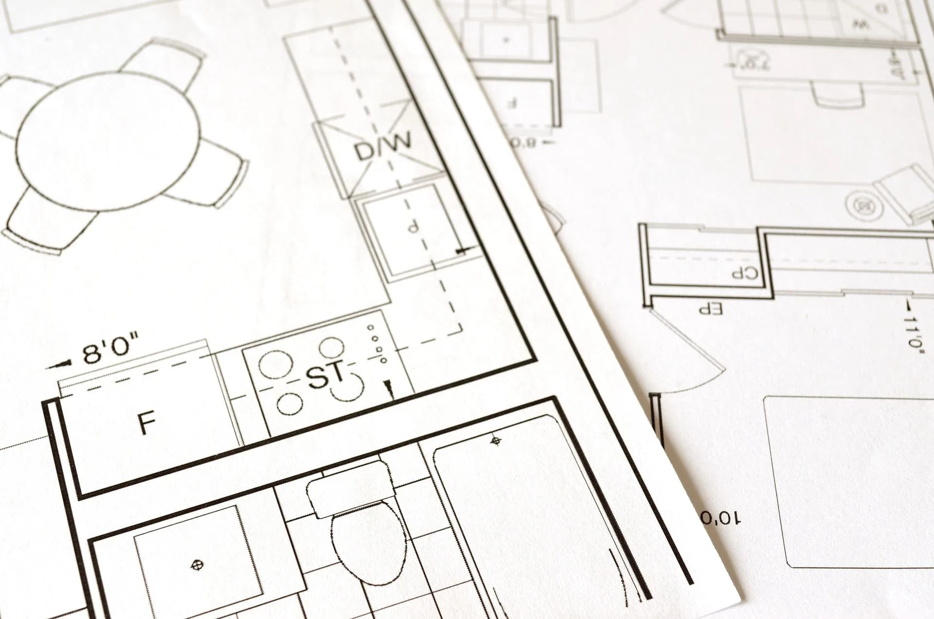Residential floor plans spread out on a table