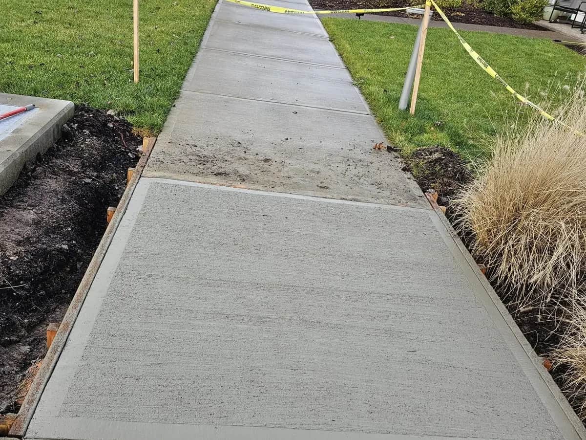 Concrete walkway connecting patio and yard